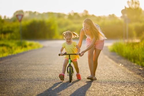 Child learning to ride bike