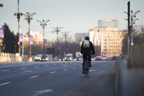 Man on a bike cycling to work on a bike he purchased through the cycle to work scheme